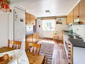 a kitchen with a table and a dining room at 7 person holiday home in LMEDBODA in Älmeboda