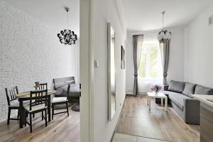 a living room with a couch and a table at Apartament w centrum :) in Krakow