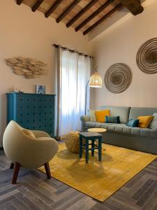 a living room with a couch and a table and a chair at Agriturismo Galenzana in Marina di Campo