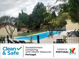 um sinal para um resort com piscina em Metro Vilar Suites & Villas em Vilar do Pinheiro