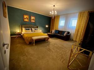a bedroom with a bed and a couch at SaraDa Boutique Luxury Apartment in Deva