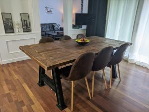 a wooden table with chairs and a bowl of fruit on it at Dalt Vila Salou Deluxe in Salou