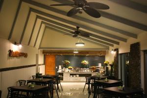 a restaurant with tables and chairs and a counter at Easter Island Ecolodge in Hanga Roa