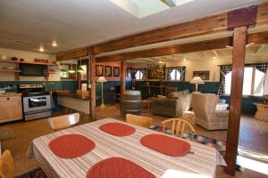 a kitchen and living room with a table and chairs at Cottage Inn by Casago McCall - Donerightmanagement in McCall