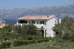 a white house with a view of the ocean at Apartments Biba & Lucy in Ražanac