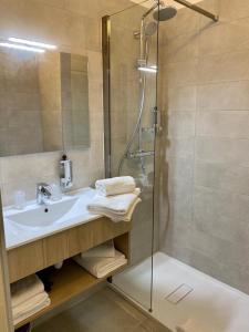 a bathroom with a sink, toilet and bathtub at Hôtel Casa Bianca in Calvi