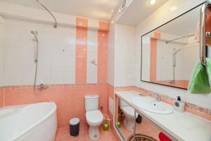 a bathroom with a toilet and a sink and a tub at Apartments on Kuznechnaya 79 in Yekaterinburg