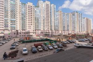 a parking lot with cars parked in front of tall buildings at Apartments on Kuznechnaya 79 in Yekaterinburg