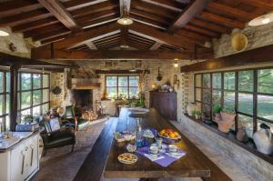 a living room with a table and a fireplace at Convento di San Francesco Mondaino in Mondaino