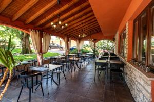 a restaurant with tables and chairs on a patio at Villa Maimare in Biograd na Moru