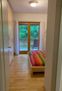 a bedroom with a bed and a door with a window at Apartment Lesnina in Kranjska Gora