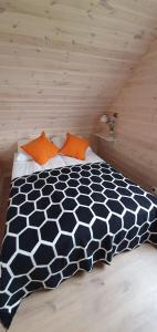 a bedroom with a black and white bed in a attic at Baltic Beach House in Rewal