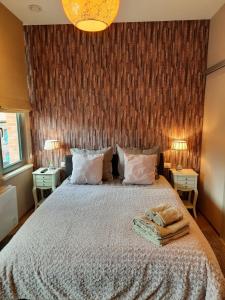 a bedroom with a large bed with two night stands at B&B Heart Of Bruges in Bruges