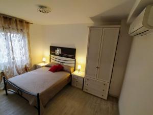 a bedroom with a bed and a large cabinet at B&B Alghero Mare Chiaro in Alghero