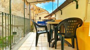 a table and two chairs sitting on a balcony at Casa Santicelli Maratea “ Il Campanile” in Maratea