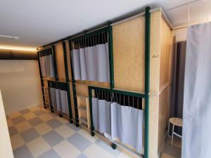 A bed or beds in a room at Green Marmot Capsule Hotel Zürich