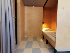 A bed or beds in a room at Green Marmot Capsule Hotel Zürich