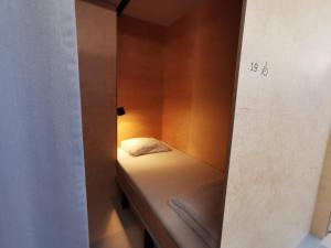 A bed or beds in a room at Green Marmot Capsule Hotel Zürich