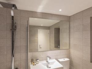 a bathroom with a sink and a mirror at 1 The Old Coach House in Dartmouth +30 photos