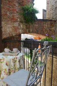 a table and a chair on a balcony at Le Stanze del Cardinale in Pavia