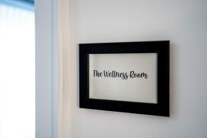 a picture frame hanging on a wall with the wellness room at The Rose Suites in Bruges