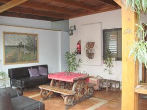 a living room with a table and a couch at Klein Hospitality in the Galilee Hagoshrim in HaGoshrim