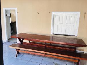 a wooden bench sitting in a room with a window at Casa de Praia Alter do Chão in Alter do Chao