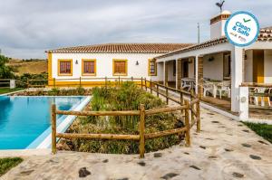 a villa with a swimming pool and a house at Horta da Quinta in Mértola