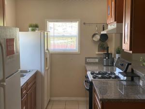a kitchen with a white refrigerator and a stove at WHOLE Family - Barrette in Sacramento