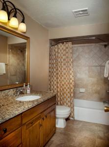 a bathroom with a sink and a toilet and a shower at GetAways at Eagle Point Resort in Vail