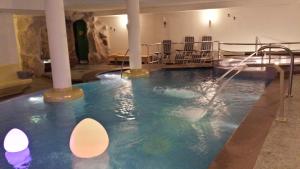 an indoor swimming pool with a water slide at Hotel Sole in Passo del Tonale