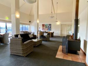 a living room filled with furniture and a large window at Surfpoint Resort in Margaret River Town