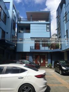 a white car parked in front of a building at Thien Anh Hotel in Hai Phong