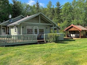 a small green house with a porch and a gazebo at 8 person holiday home in jørpeland-By Traum in Jørpeland