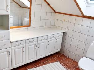 a bathroom with a sink and a mirror at 10 person holiday home in MIDSUND in Midsund +44 photos