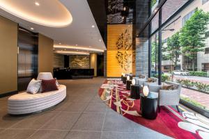 a lobby with couches and chairs in a building at Hotel Vista Tokyo Tsukiji in Tokyo