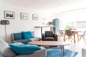 a living room with a couch and a table at Spacieux T2 remis à neuf, à 3 min des plages, terrasse in Anglet