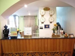 a store counter with clocks on the wall at Grand Laurel Hotel in Yangon