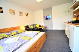 a small room with a bed and a kitchen at Villa Vanilla in Liptovský Mikuláš