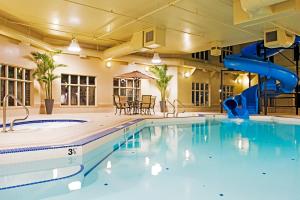 a swimming pool with a slide in a building at Holiday Inn Express Grande Prairie, an IHG Hotel in Grande Prairie