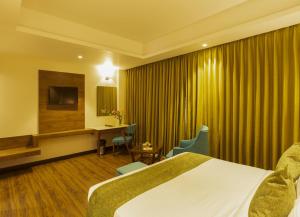 Sarovar Portico, Somnath客房内的一张或多张床位