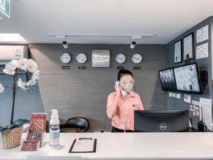 a man talking on a cell phone in an office at Casa Residence Hotel in Bangkok
