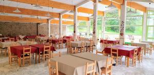 a dining room with tables and chairs and windows at CIS-Ethic Etapes de Val Cenis in Lanslebourg-Mont-Cenis