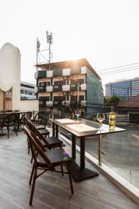 a table and chairs on the roof of a building at The 8 Hotel Udonthani in Udon Thani