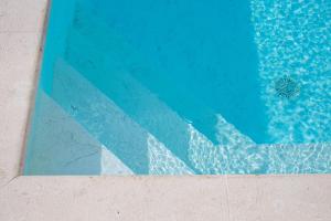 a close up of a blue swimming pool at Casa Bela in Klimno