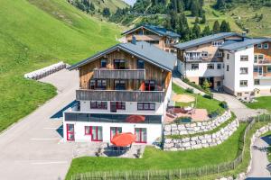 an aerial view of a house on a hill at Haus Rothorn in Schröcken