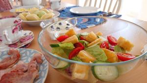 a salad in a glass bowl on a table at Straybirds in Donghe