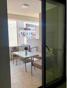 a room with a table and chairs and a window at Apartment Luxury in Râmnicu Vâlcea