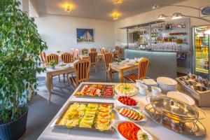 a buffet of food on a table in a restaurant at Murena Hotel i Restauracja in Ustronie Morskie