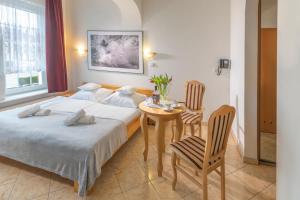 Postel nebo postele na pokoji v ubytování Murena Hotel i Restauracja
